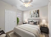 Thumbnail 11 of 14 - A bedroom with a large bed and a ceiling fan.