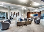 Thumbnail 15 of 22 - A modern living room with grey and brown furniture.