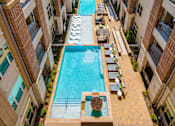 Thumbnail 21 of 22 - A swimming pool in the middle of apartment buildings.