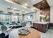 Thumbnail 17 of 22 - A modern living room with a large wooden table and comfortable seating.
