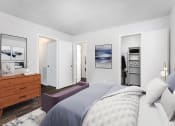 Thumbnail 24 of 25 - a bedroom with a bed and a dresser