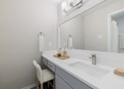 Thumbnail 8 of 31 - A white chair is in front of a white sink.