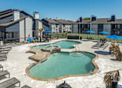 Thumbnail 32 of 66 - a resort style pool with chairs and umbrellas in front of a building