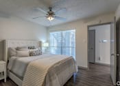 Thumbnail 31 of 66 - a bedroom with a bed and a ceiling fan
