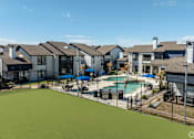 Thumbnail 37 of 66 - a view of a swimming pool with apartments in the background