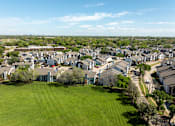 Thumbnail 39 of 66 - an aerial view of a neighborhood with houses and grass