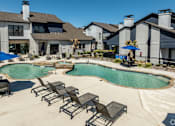 Thumbnail 33 of 66 - the preserve at ballantyne commons swimming pool with chairs and umbrellas
