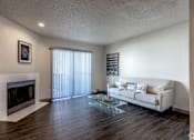 Thumbnail 29 of 66 - a living room with a white couch and a glass coffee table