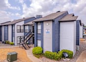 Thumbnail 54 of 66 - a row of townhomes with blue and white buildings with stairs