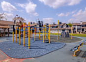 Thumbnail 49 of 66 - an empty playground at a neighbourhood park with houses
