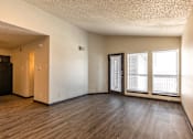 Thumbnail 43 of 66 - an empty living room with wood floors and a window