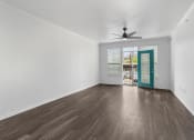 Thumbnail 8 of 25 - a living room with white walls and a blue door