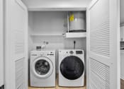 Thumbnail 22 of 25 - a small laundry room with a washer and a dryer