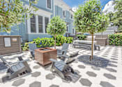 Thumbnail 21 of 23 - A patio with a checkered floor and grey chairs.