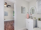 Thumbnail 16 of 23 - A bathroom with a white sink and a white tub.