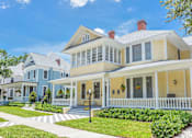 Thumbnail 23 of 23 - A large house with a blue and yellow exterior.