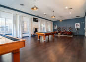 Thumbnail 29 of 36 - a game room with a pool table and a tv