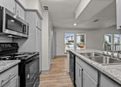 Thumbnail 59 of 66 - a kitchen with granite counter tops and stainless steel appliances