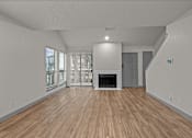 Thumbnail 60 of 66 - an empty living room with a fireplace and wood flooring