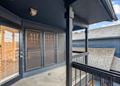Thumbnail 65 of 66 - a balcony with a view of a building with windows and a porch