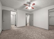 Thumbnail 62 of 66 - an empty living room with a ceiling fan and a closet