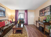 Thumbnail 6 of 18 - a living room with a leather couch and coffee table