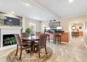 Thumbnail 14 of 18 - a dining area with a table and chairs and a fireplace