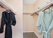 Thumbnail 11 of 32 - a walk in closet with a mirrored medicine cabinet