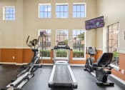 Thumbnail 16 of 35 - a gym with two treadmills and two ellipticals