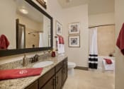 Thumbnail 6 of 23 - a bathroom with a sink and a toilet and a mirror