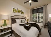 Thumbnail 8 of 23 - a bedroom with a bed and a ceiling fan