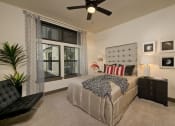 Thumbnail 5 of 23 - a bedroom with a bed and a ceiling fan