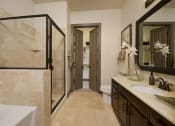Thumbnail 9 of 23 - a bathroom with a sink and a shower and a toilet
