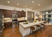 Thumbnail 2 of 23 - a kitchen with a large island and stainless steel appliances