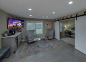 Thumbnail 14 of 19 - business center area with two chairs,  a tv and an office next door