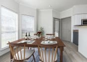 Thumbnail 3 of 23 - a kitchen and dining room with a wooden table and chairs