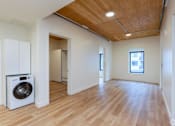 Thumbnail 2 of 15 - A room with a washing machine and a window.