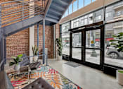 Thumbnail 1 of 15 - A modern interior with a staircase and a colorful rug.