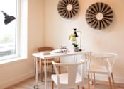 Thumbnail 15 of 15 - A dining room with a white table and chairs.
