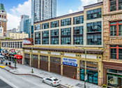 Thumbnail 13 of 15 - A street view of a city with a building that has a "No Leasing" sign.