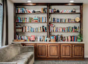 Thumbnail 11 of 22 - A bookshelf filled with books of various sizes and colors.