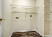 Thumbnail 7 of 22 - A room with a white door and a white wall with a shelf on the wall.