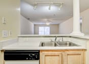 Thumbnail 3 of 22 - A kitchen with a black dishwasher and a white countertop.