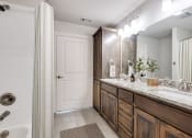 Thumbnail 6 of 42 - a bathroom with a sink and a mirror and a shower