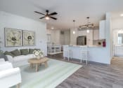 Thumbnail 26 of 65 - an open living room and kitchen with a ceiling fan