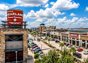 Thumbnail 5 of 35 - A view of a town center with a sign that reads "Pearland Town Center".