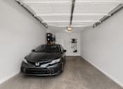 Thumbnail 19 of 20 - A black Honda Civic is parked in a garage.