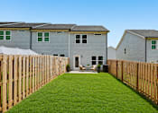 Thumbnail 56 of 56 - A row of houses with a green lawn in front.