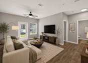 Thumbnail 3 of 20 - A living room with a couch, a coffee table, a television, and a ceiling fan.