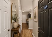 Thumbnail 4 of 20 - A hallway with a black door on the right and a white door on the left.